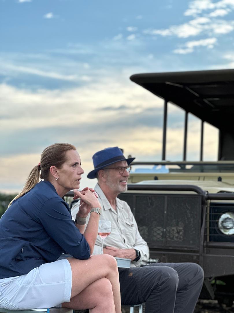 Gallivanters safari guests enjoying a sundowner in the Tanzanian landscape