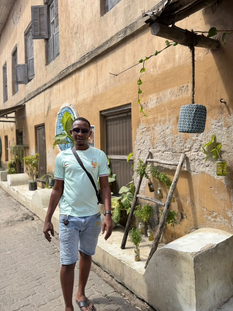Kibwana exploring a coastal street during his travels.